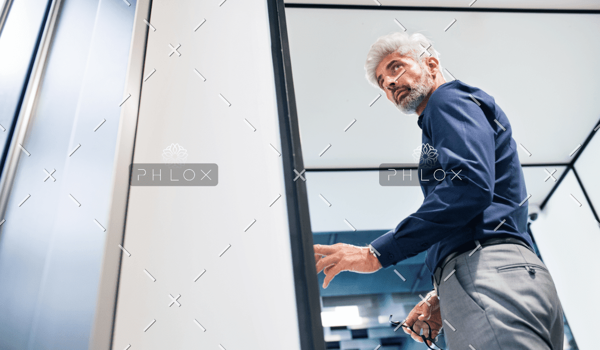 Mature Businessman In The Office Standing P4MENHG